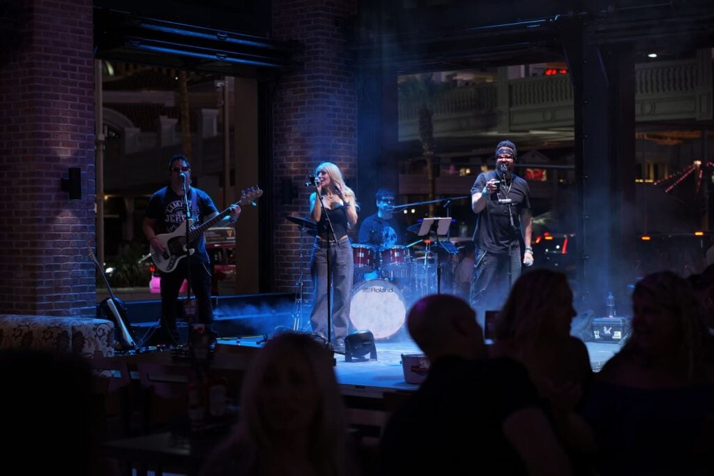 Live band with female vocalist performing on indoor stage