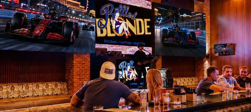 Guests at the Bottled Blonde bar watching race coverage on large screens