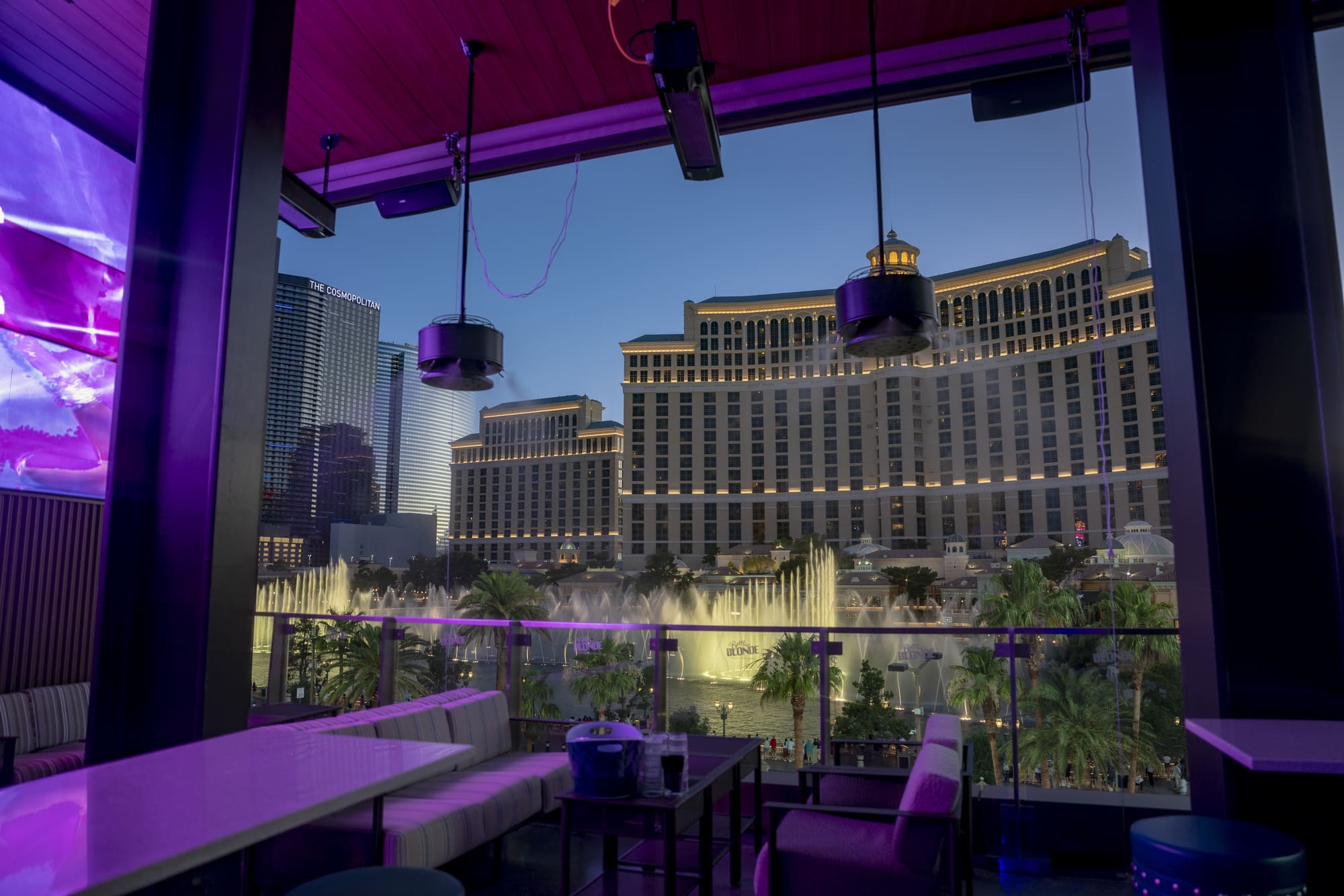 Lounge seating on a rooftop patio overlooking the Bellagio fountains and Las Vegas skyline.