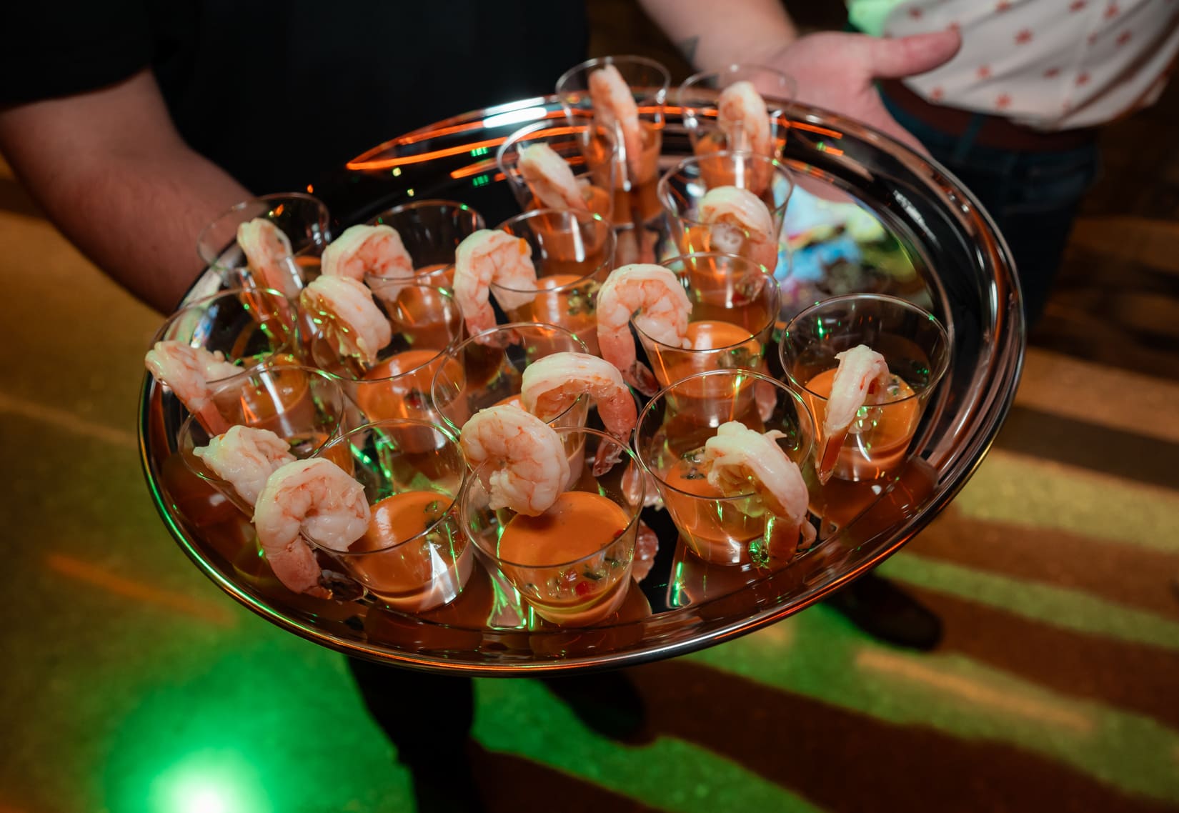 Tray of shrimp cocktail appetizers served in small clear cups.