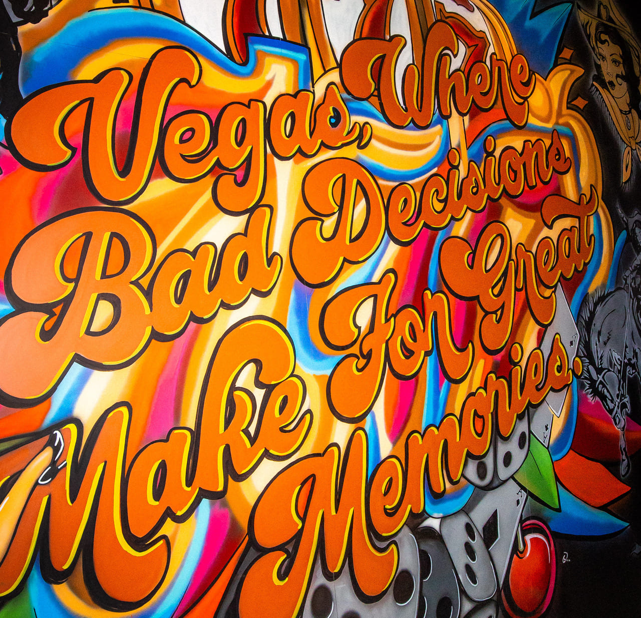 Colorful mural reading “Vegas, where bad decisions make for great memories” with dice and cherries artwork.