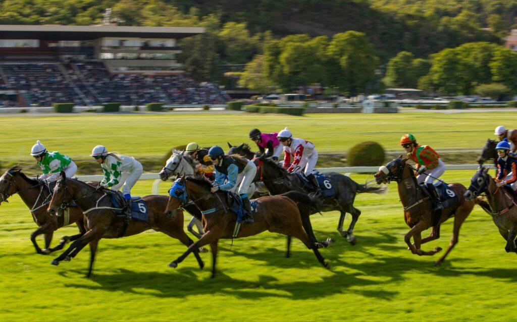 Jockeys racing horses on a track during a live horse racing event