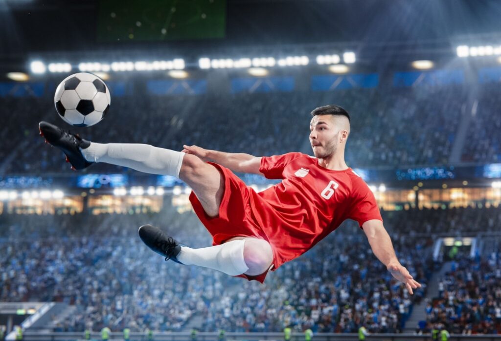 Soccer player performing a mid-air kick during a match in a stadium